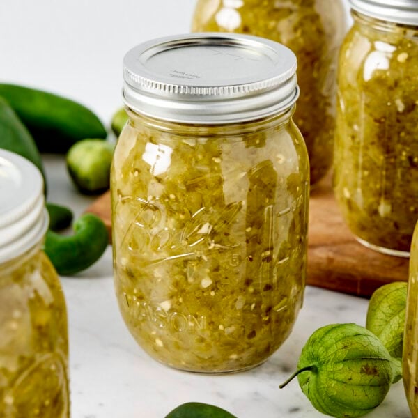Jars of canned tomatillo salsa verde.