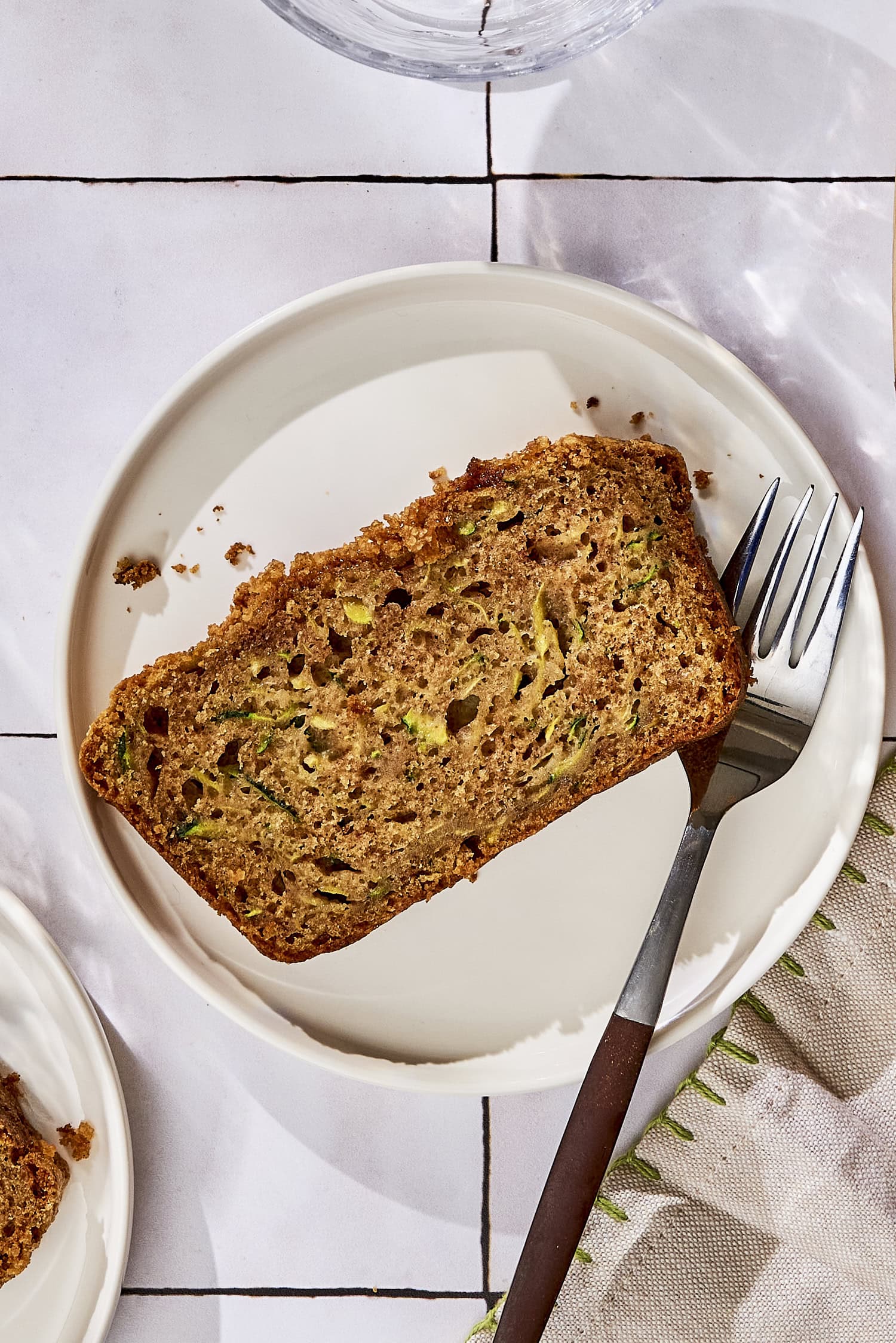 Plate with slice of zucchini bread.