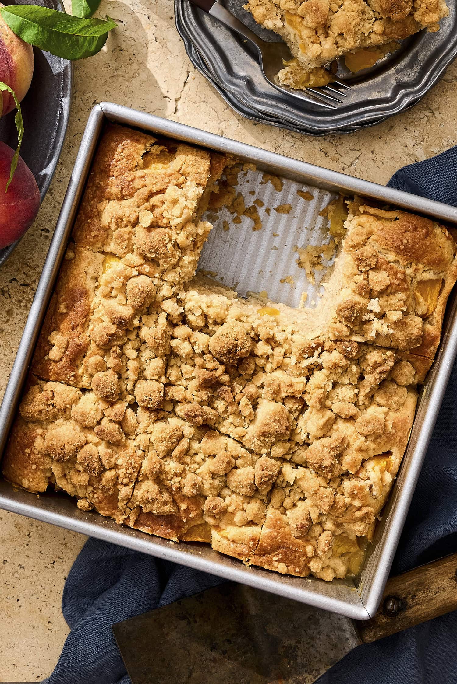 Pan filled with pieces of peach coffee cake.