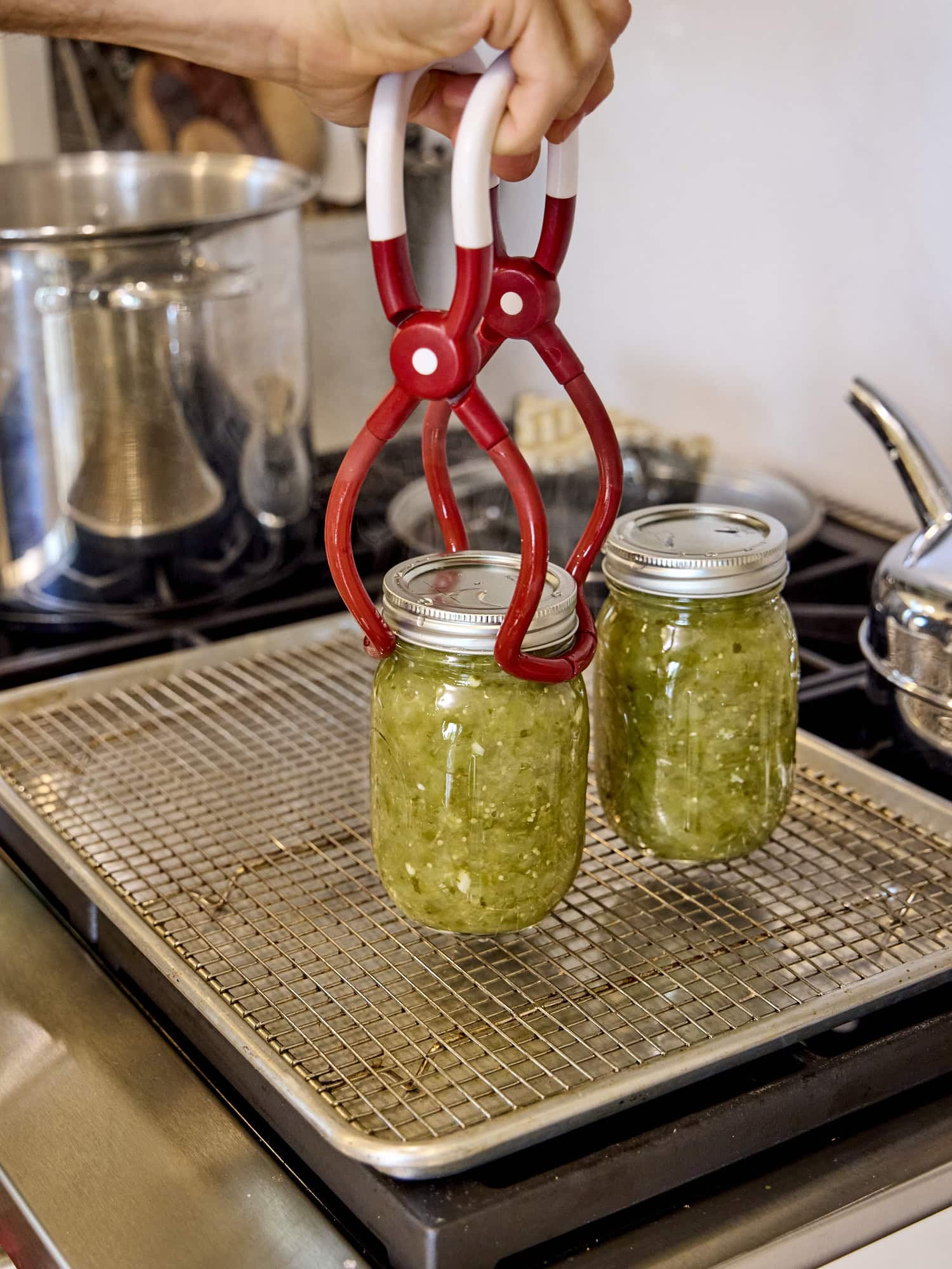 Taking canned jars out of the water bath canner.