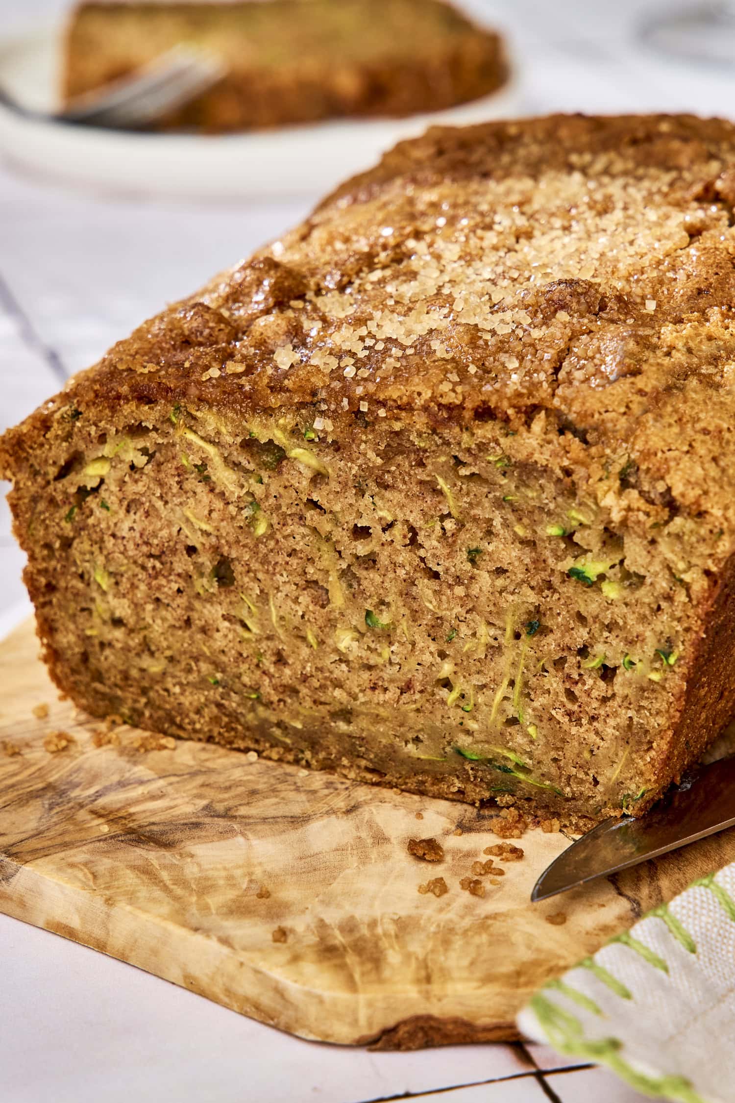 Zucchini bread on wooden board showing interior texture.