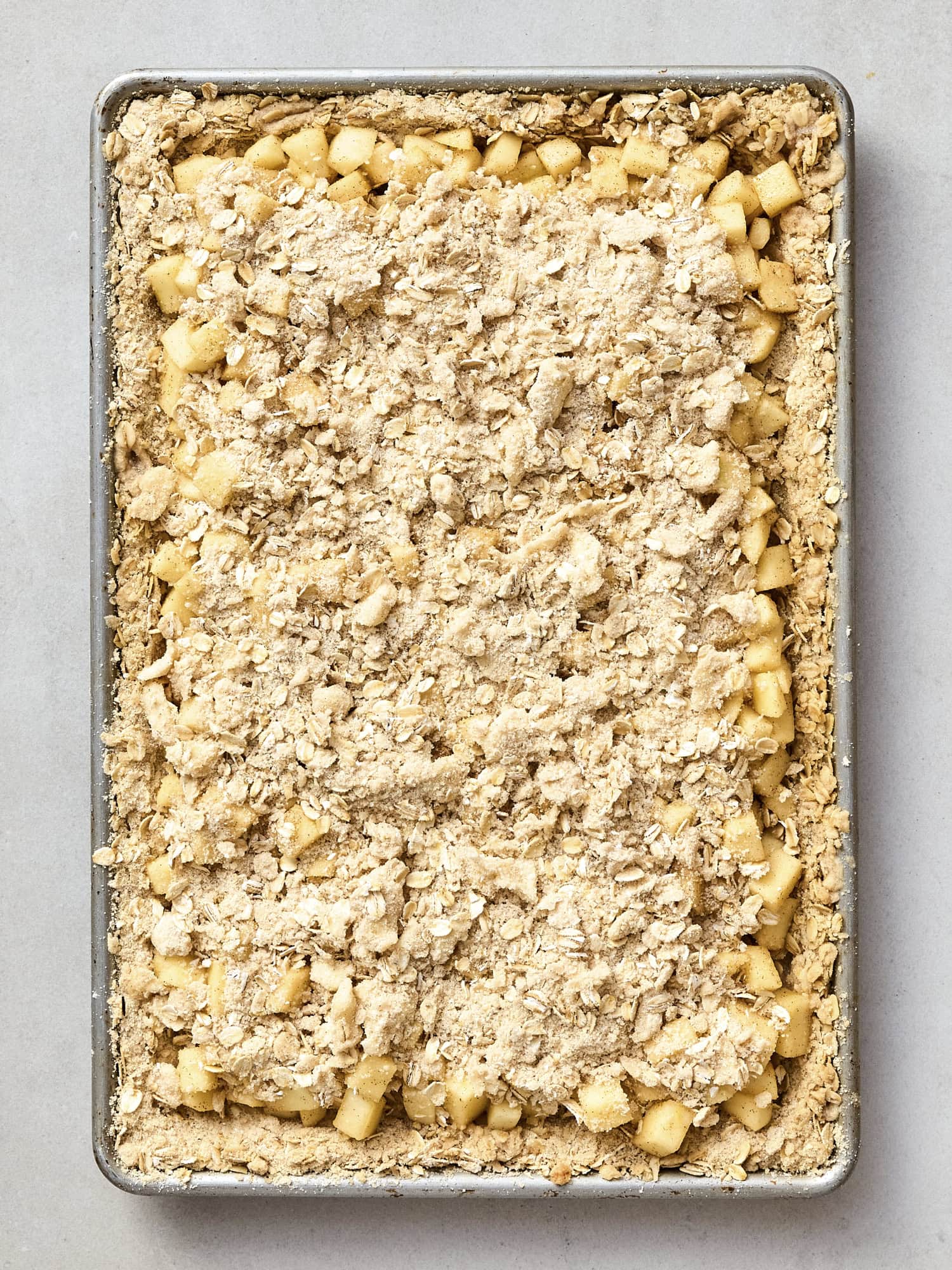 Apple pie bars with streusel topping before being baked.