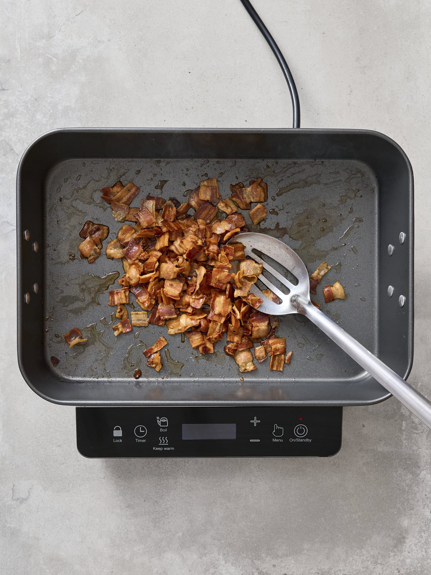 Cooking pancetta in a pan.