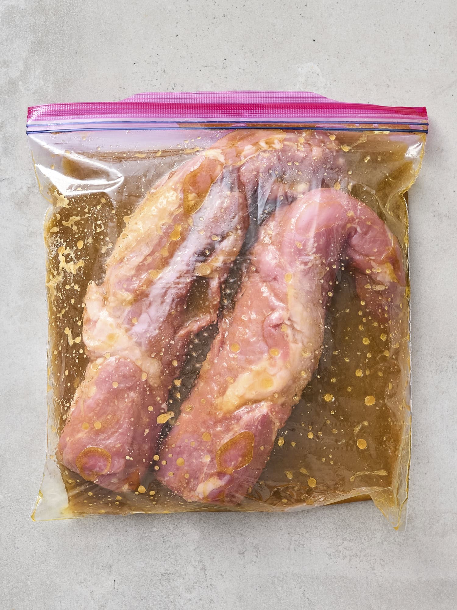 Marinating pork tenderloins in bag.