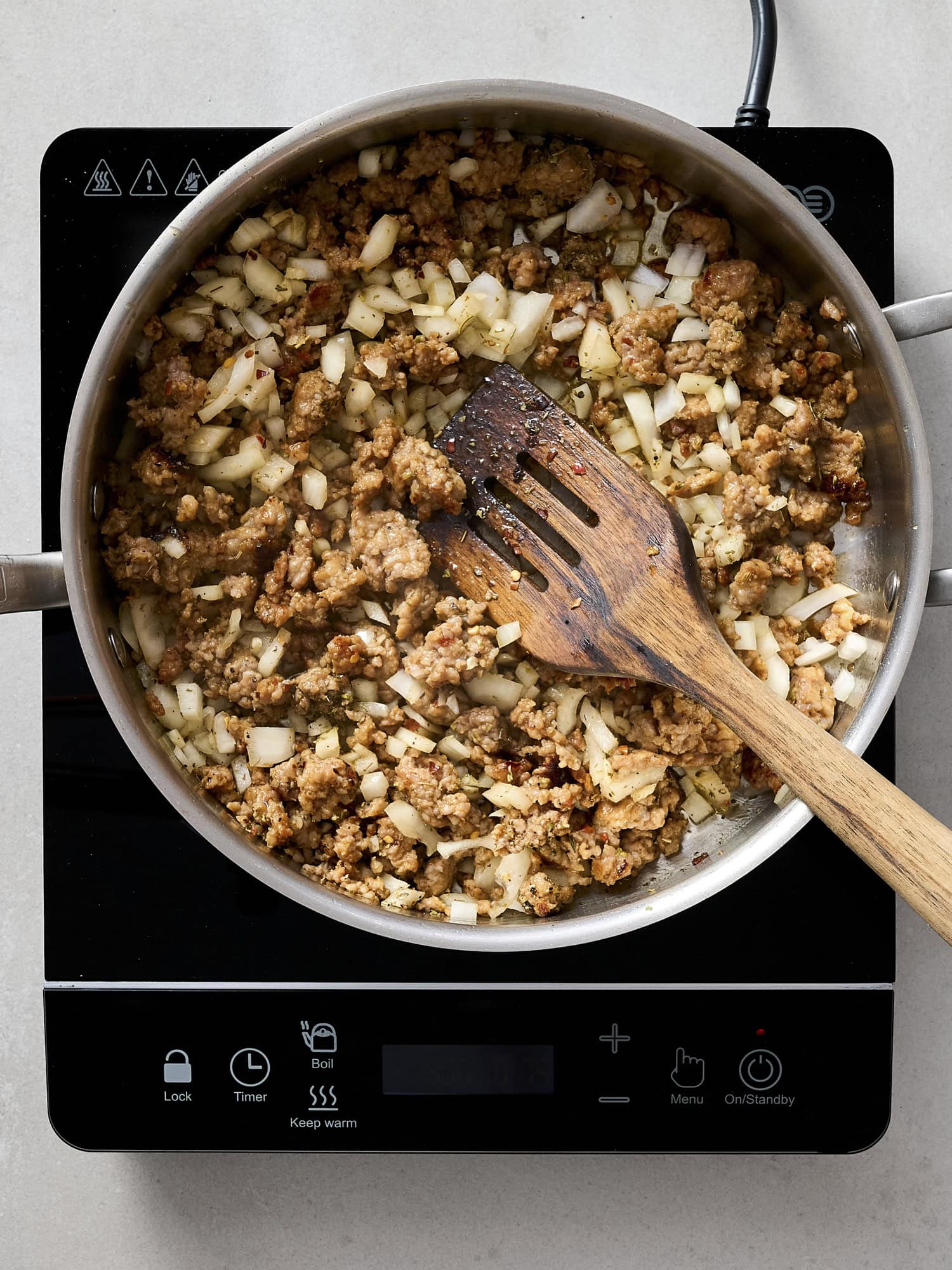 Cooking sausage with onion and garlic.