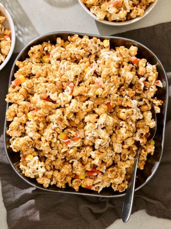 Bowl filled with peanut butter popcorn with candy corn.