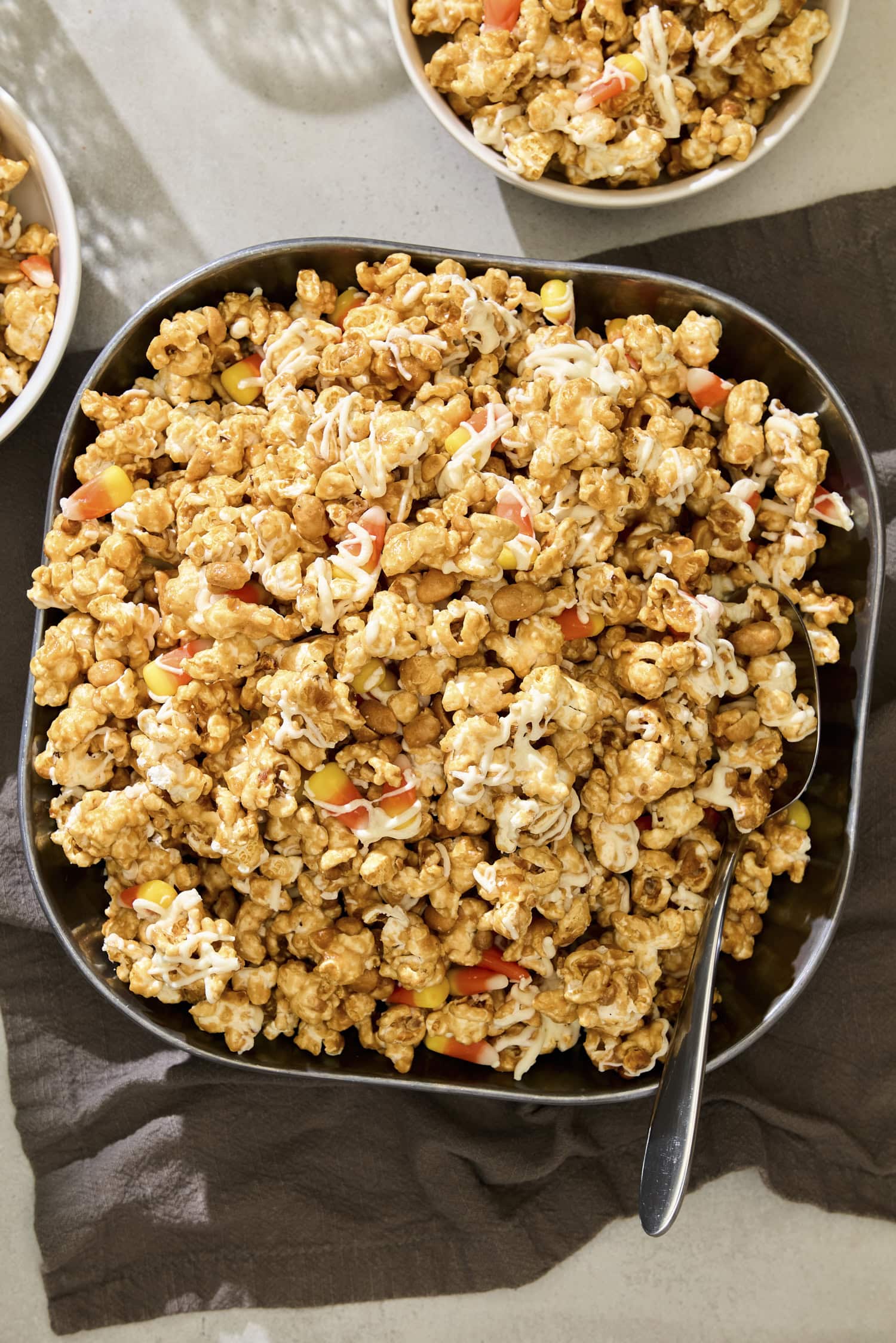 Bowl filled with peanut butter popcorn with candy corn.