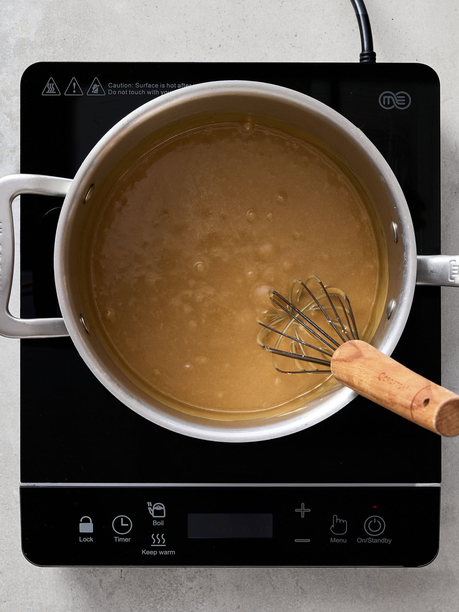 Melting brown sugar with corn syrup for caramel.