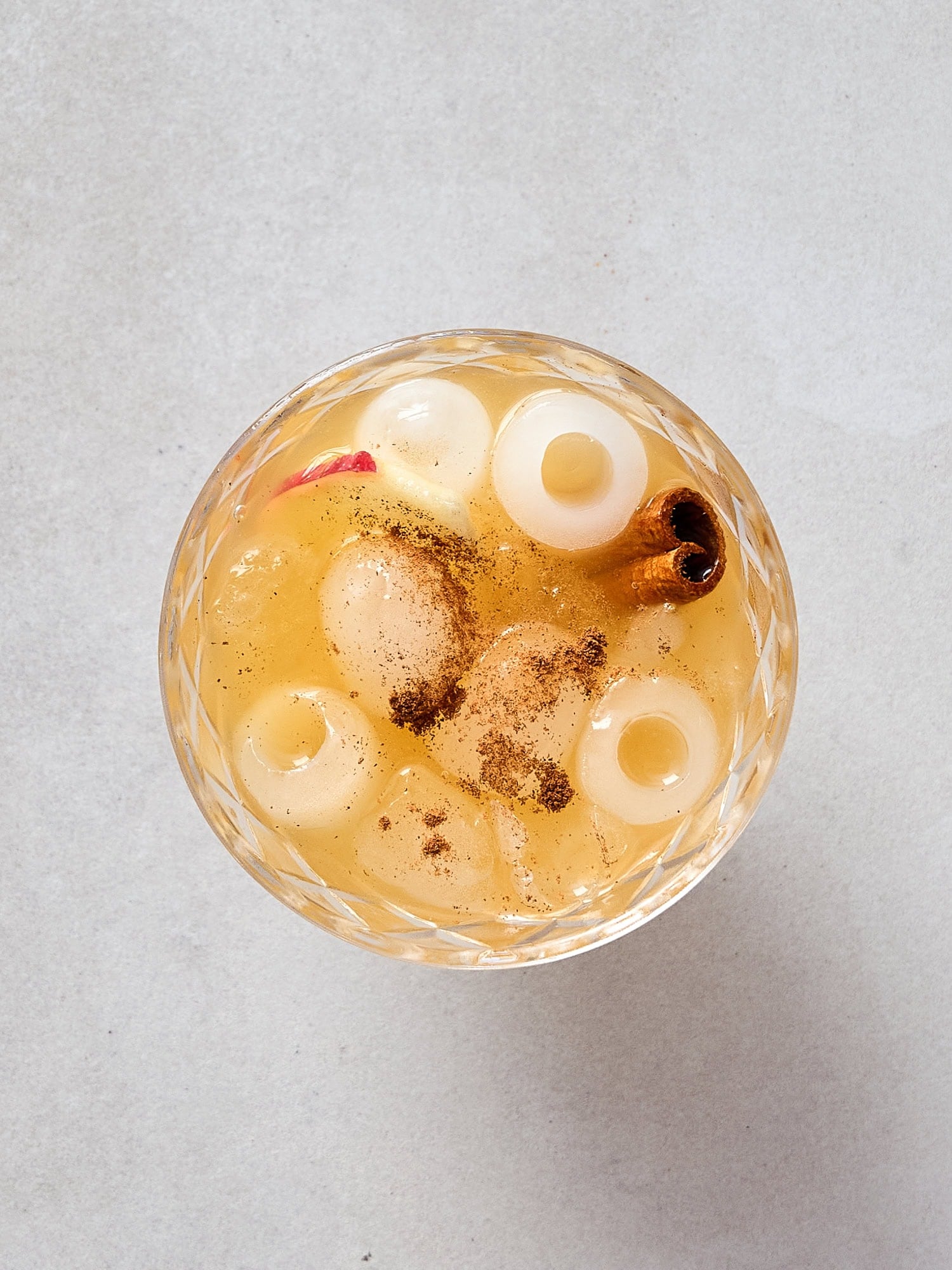 A dusting of cinnamon sits on top of an apple cider margarita.