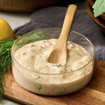 Glass bowl with BBQ ranch dressing.
