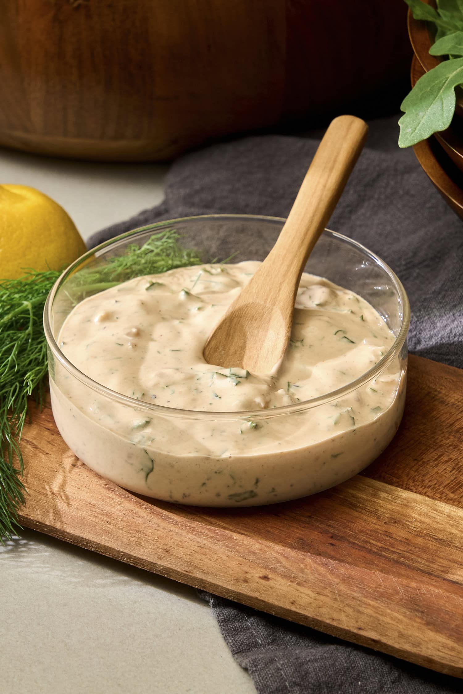 Spoon in bowl of BBQ ranch dressing.