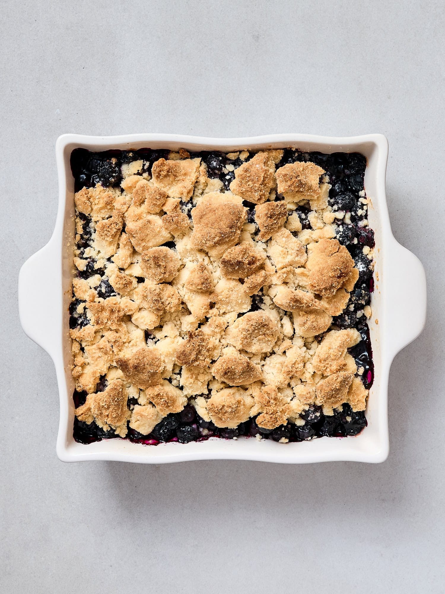 Baked blueberry crumble in a large dish.