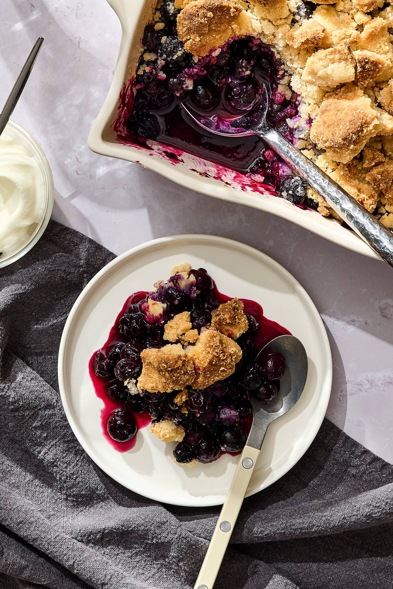 A scoop of blueberry crumble on a small plate.