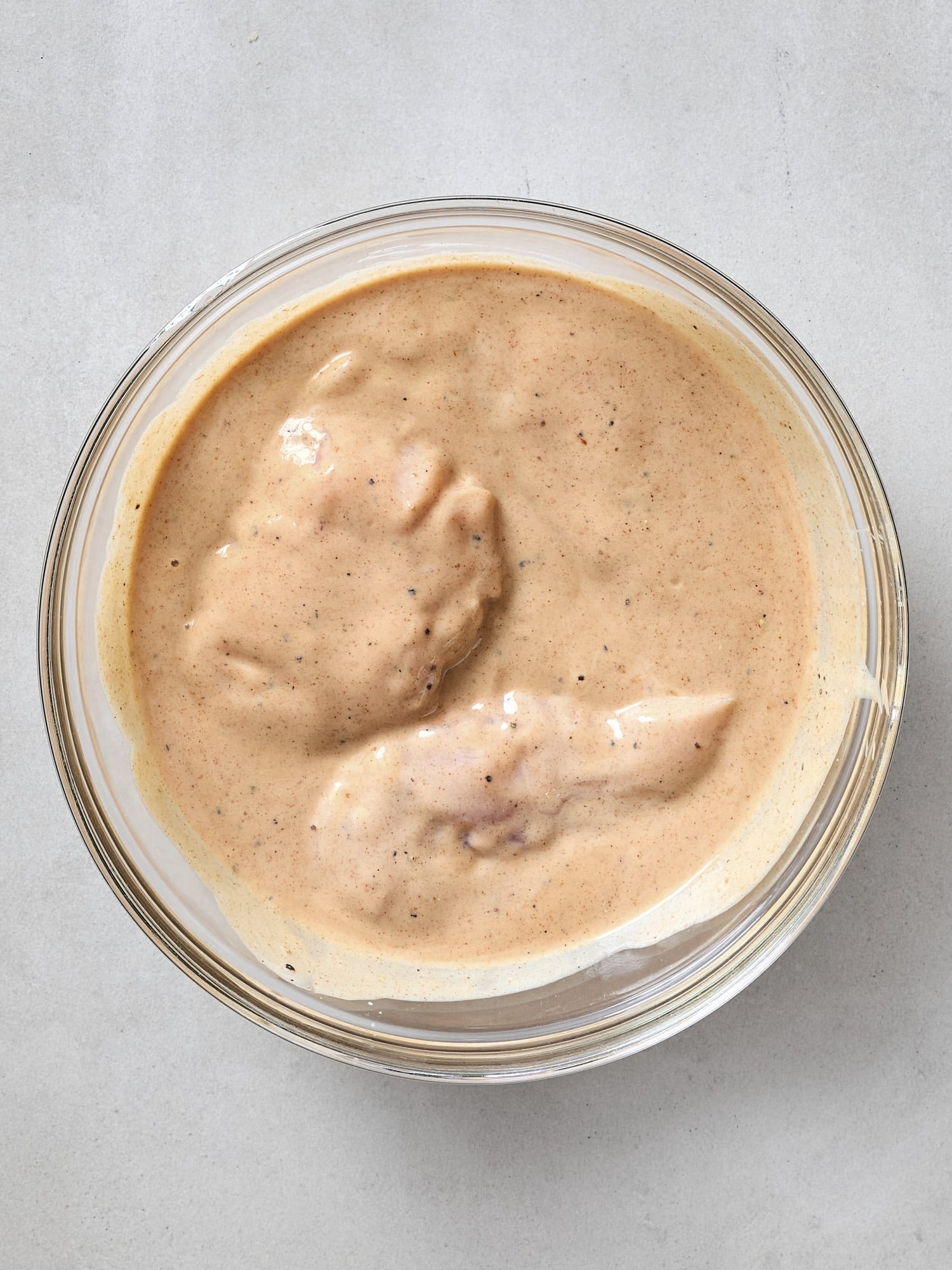 Marinating chicken in buttermilk brine.