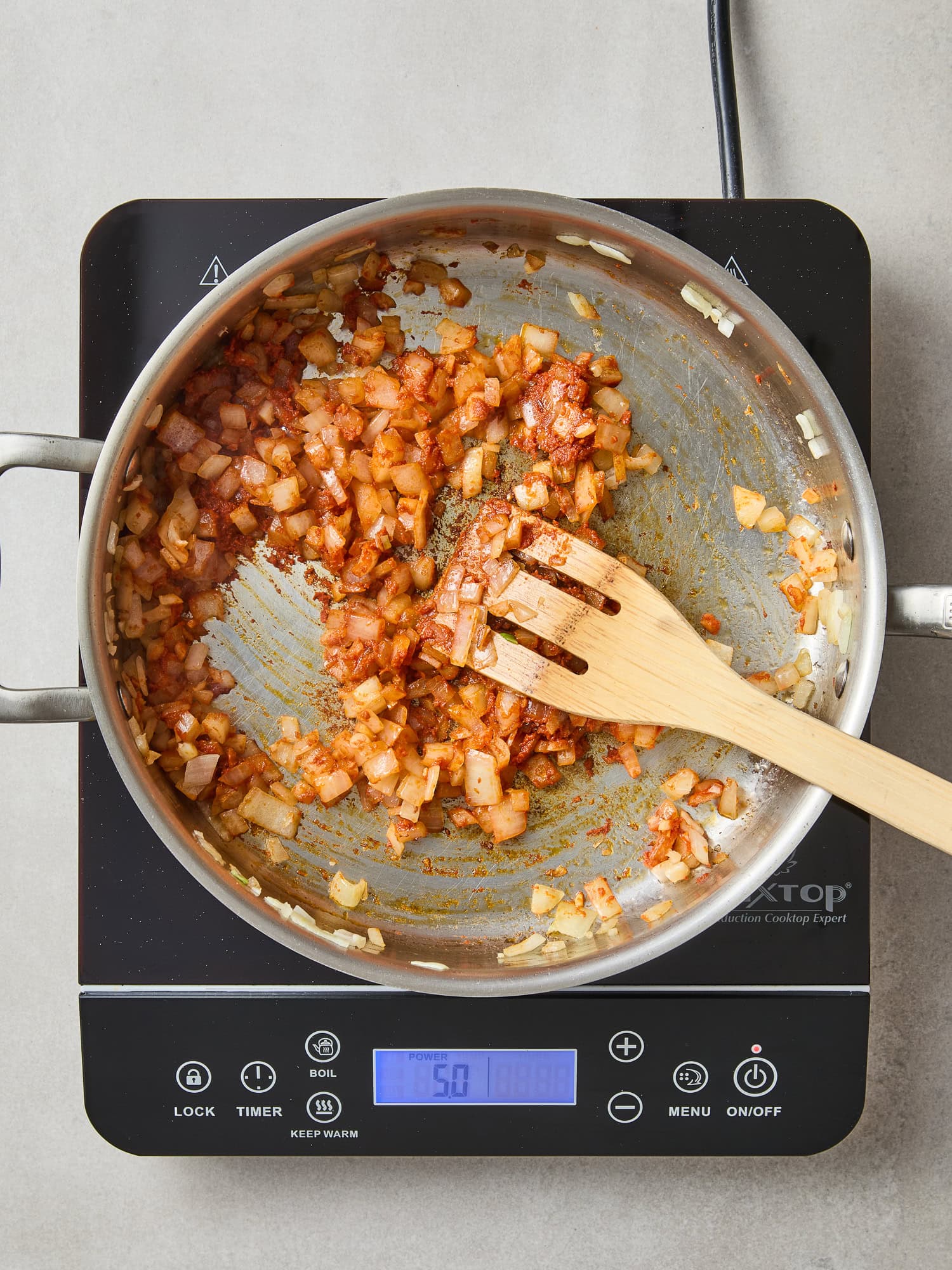 Red curry paste cooks off with onions and garlic.