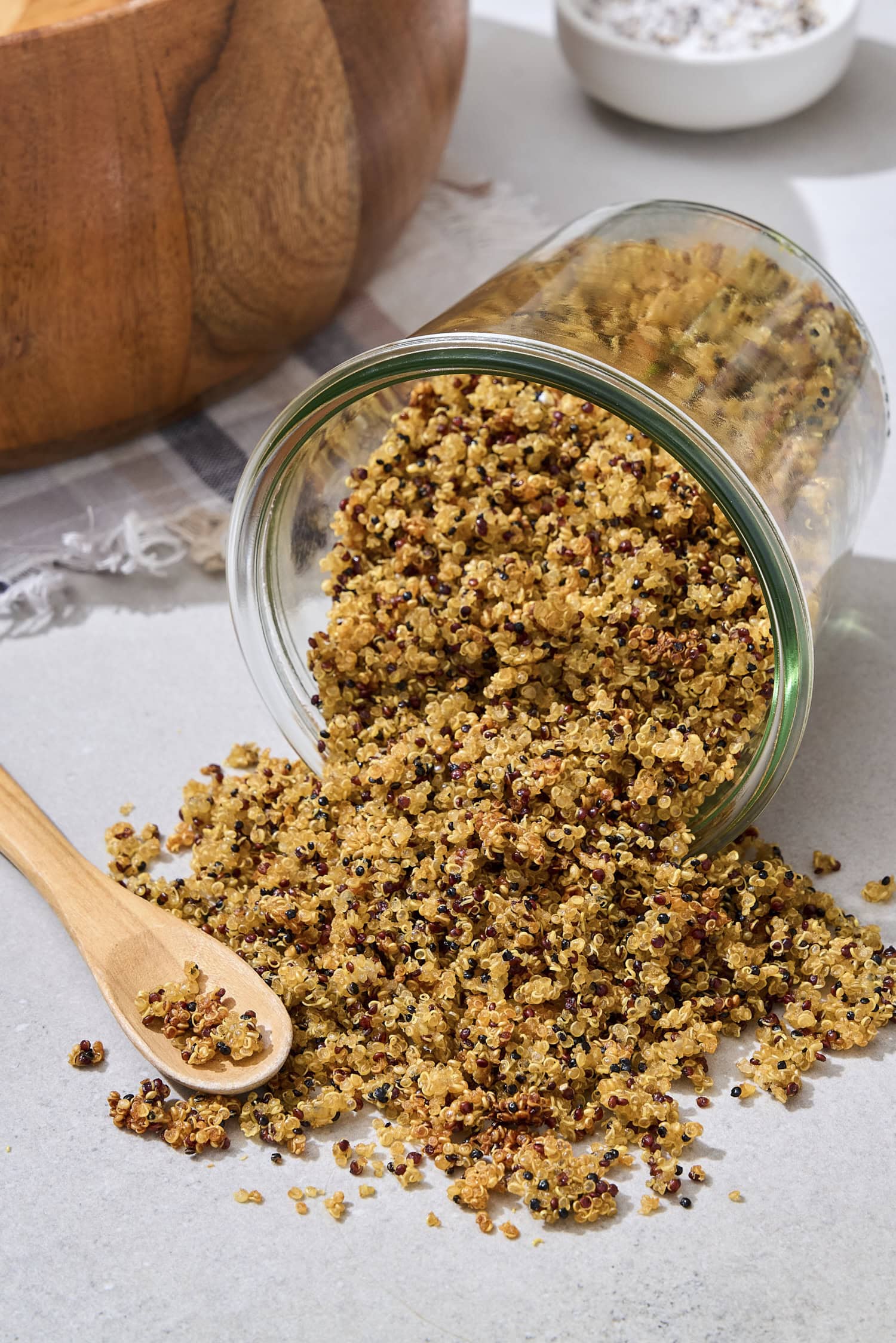 Jar on its side with crispy quinoa tumbling out.