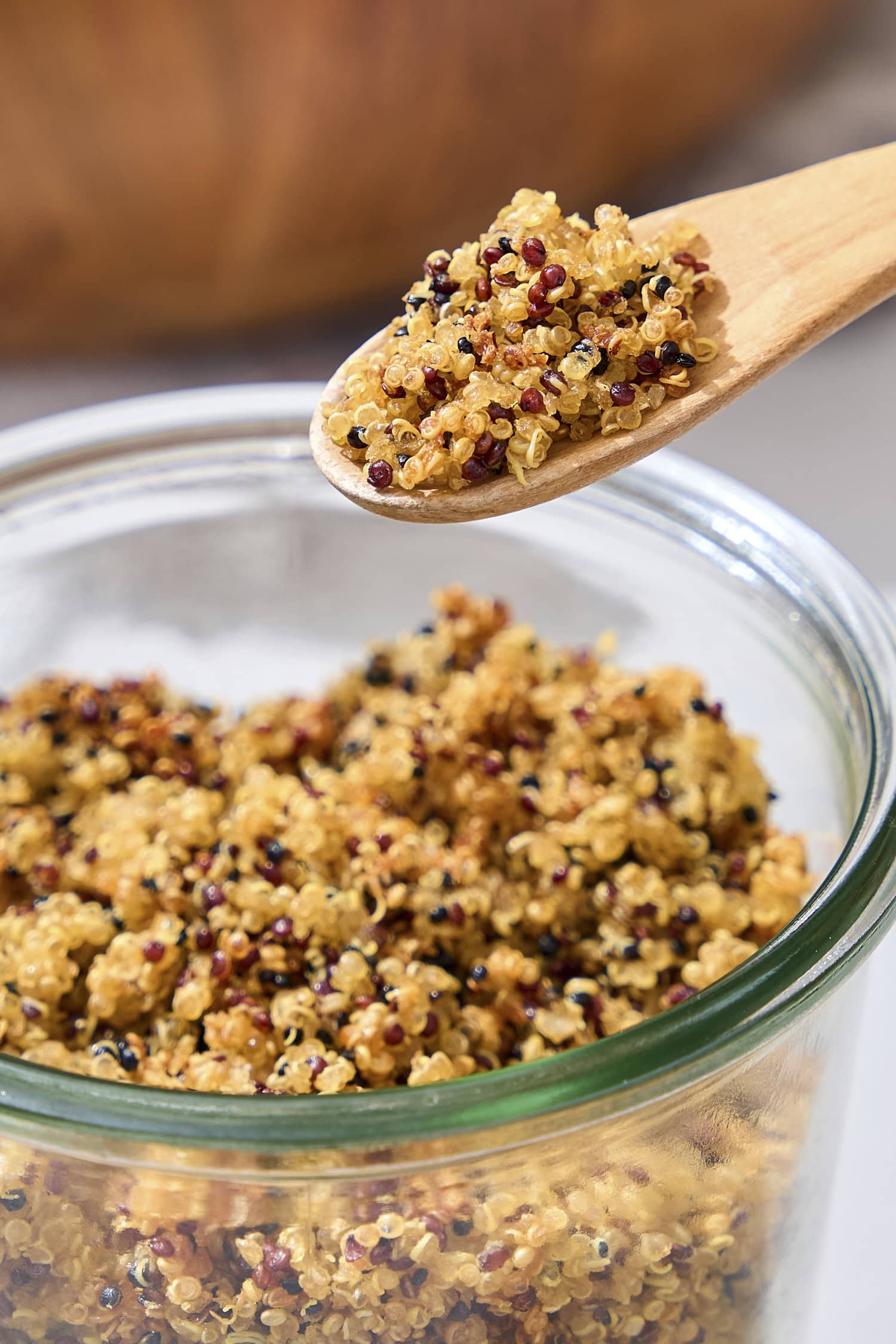 Spoon holding crispy quinoa.