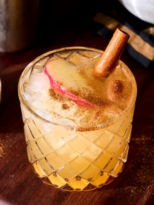 Apple cider margarita garnished with apple slice and cinnamon.