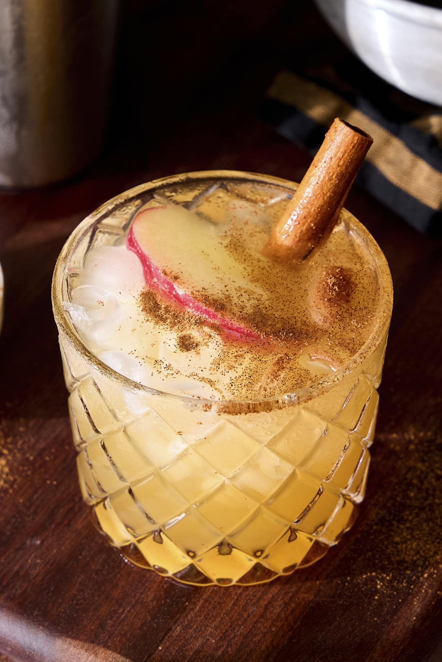 Apple cider margarita garnished with apple slice and cinnamon.