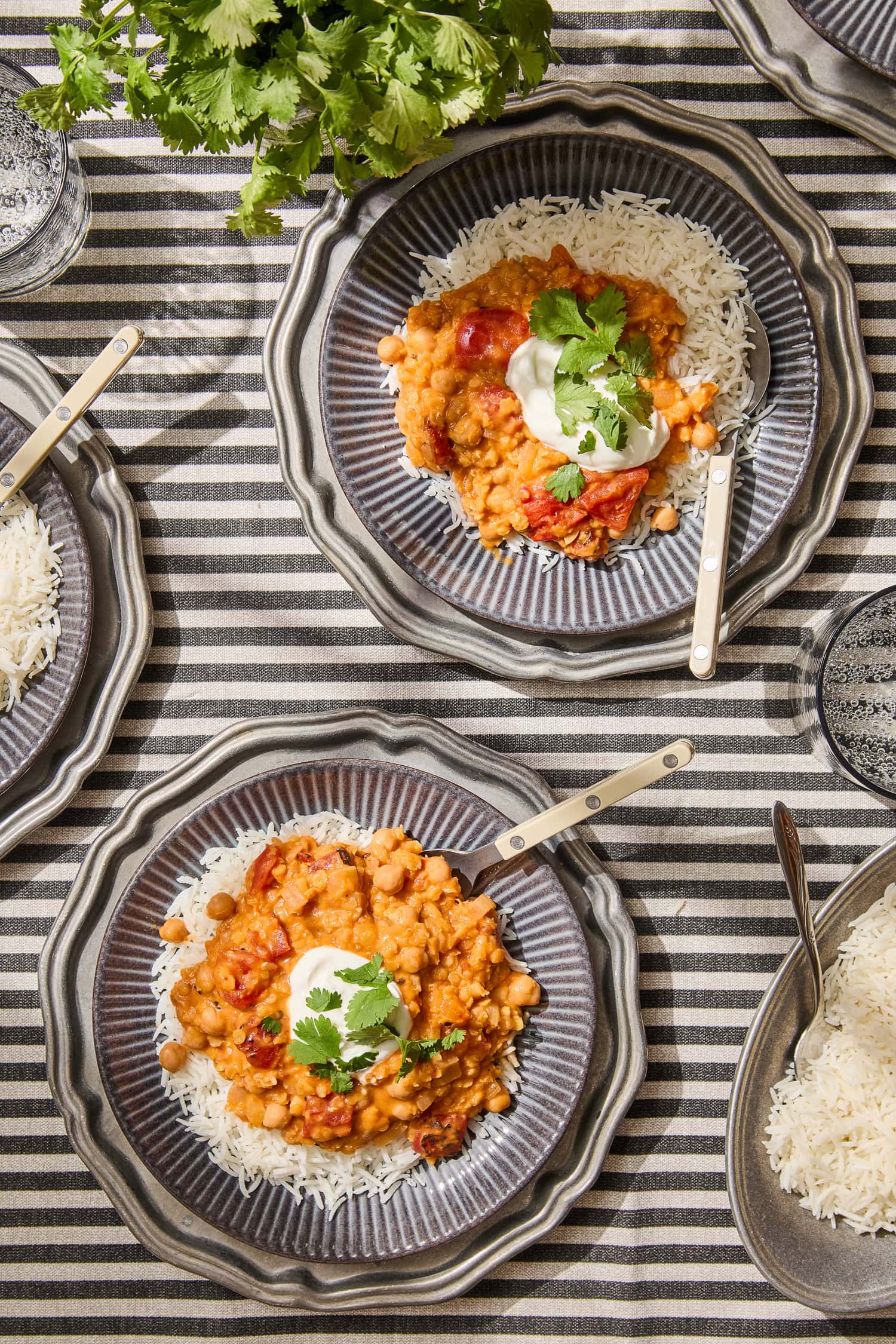 Two plates of lentil and chickpea curry serving.