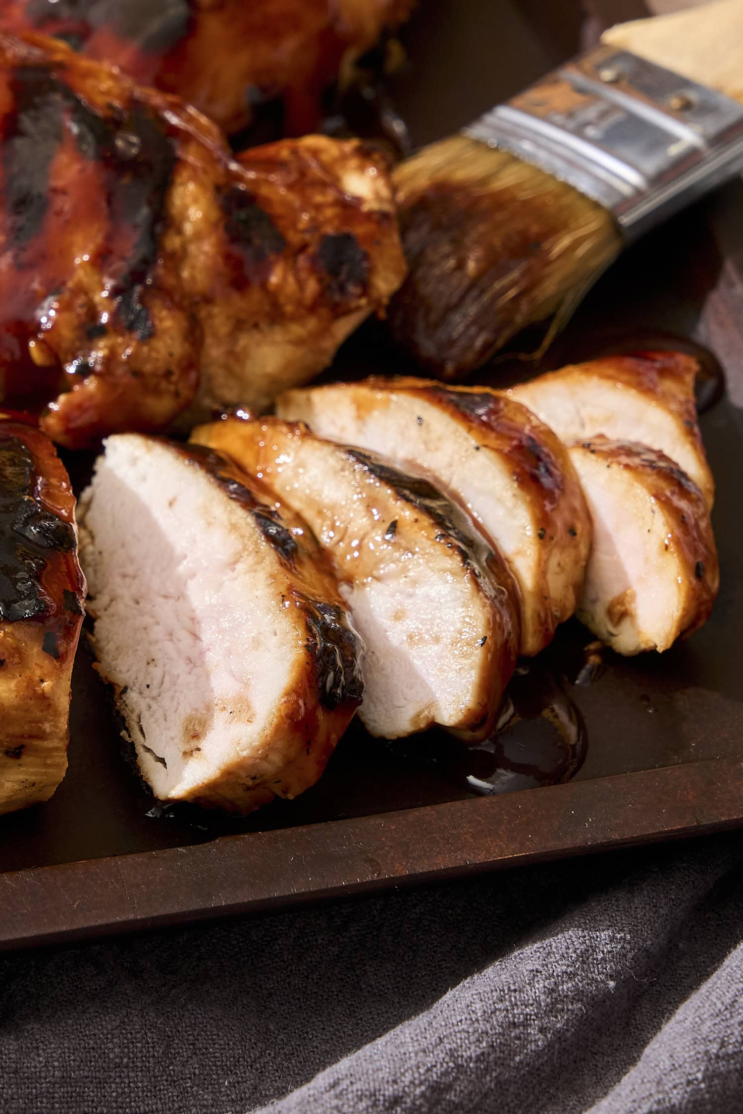 Sliced grilled chicken with BBQ sauce.
