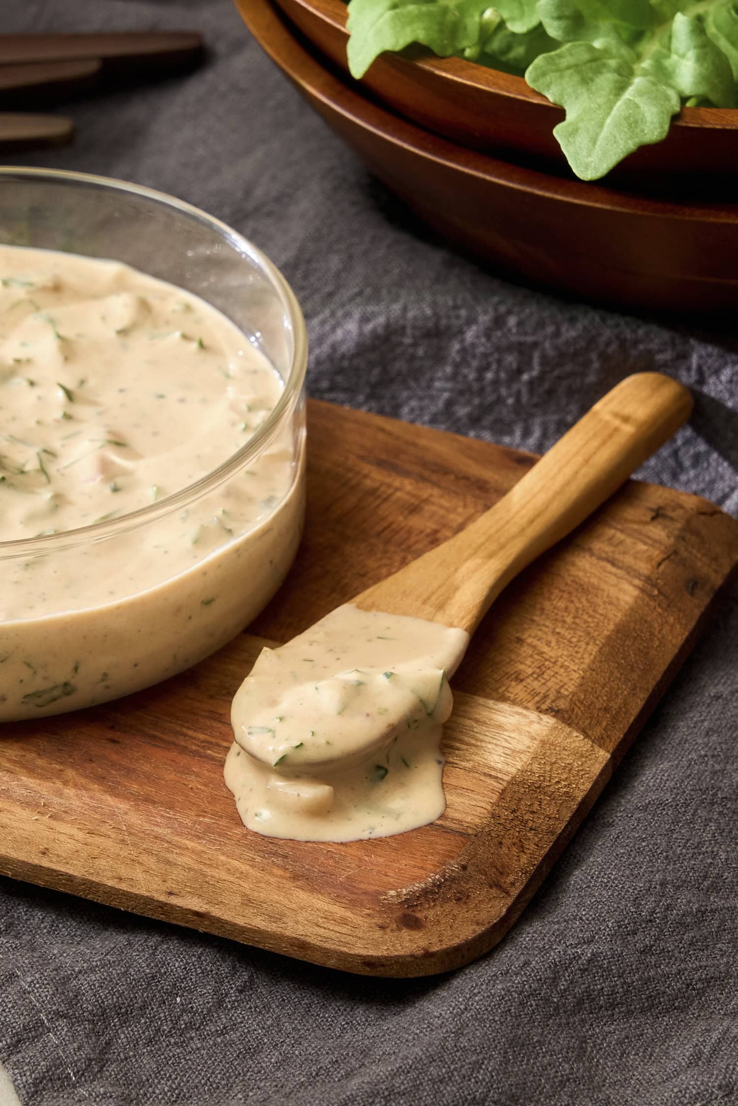 Spoon on cutting board with BBQ ranch dressing.