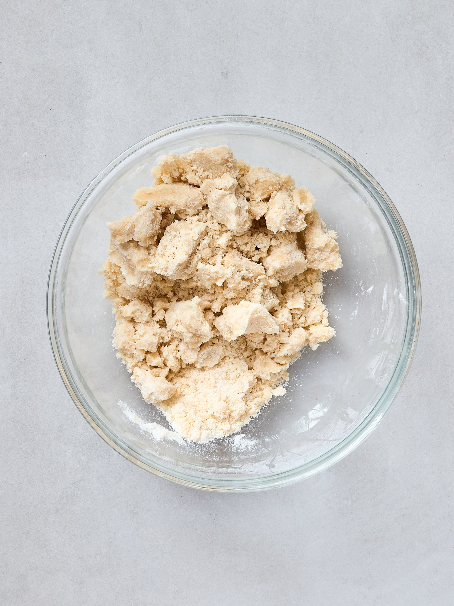 Crumble topping for baking in a small glass bowl.